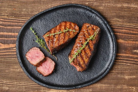 Closeup view of grilled beef brisket flat steak on a plate