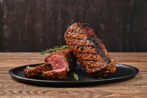 Closeup view of roasted beef brisket flat steak on a plate