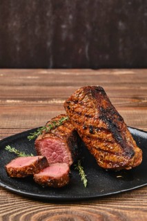 Closeup view of grilled beef brisket flat steak on wooden table