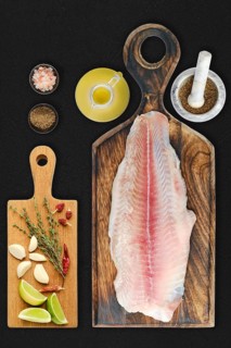 Fresh raw fillet of pangasius on black background