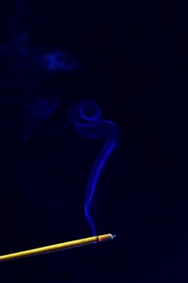 Blue smoke plume from an incense stick