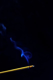 Blue smoke plume from an incense stick