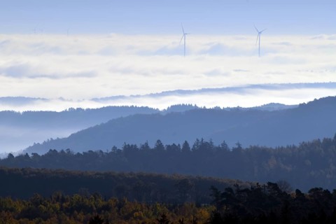 View from Moerschieder Burr mountain in the Hunsrueck-Hochwald National Park over the Naheland and North Palatinate mountains on a misty autumn morning