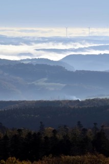 View from Moerschieder Burr mountain in the Hunsrueck-Hochwald National Park over the Naheland and North Palatinate mountains on a misty autumn morning