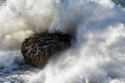 Rock in mighty surf