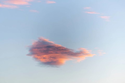 Sky of pink and orange clouds in the evening at sunset. Alsace