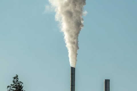Column with smoke coming out of an industrial chimney. France