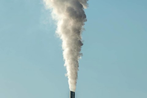 Column with smoke coming out of an industrial chimney. France