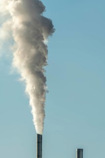 Column with smoke coming out of an industrial chimney. France