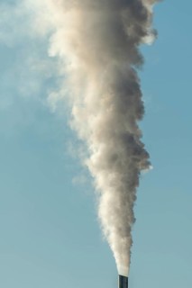 Column with smoke coming out of an industrial chimney. France