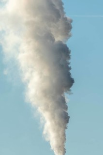 Column with smoke coming out of an industrial chimney. France