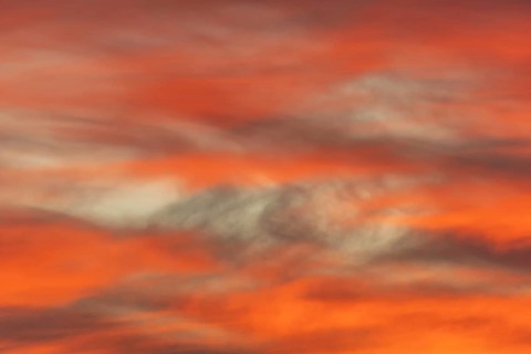Sky of pink and orange clouds in the evening at sunset. Alsace