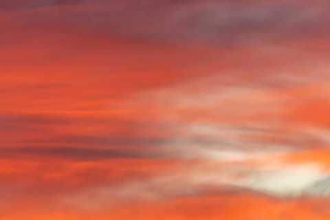 Sky of pink and orange clouds in the evening at sunset. Alsace