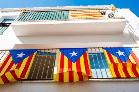Three independentist flags known as Esteladas hanging from the balcony of a house in a town on the Costa Brava in the province of Gerona in Catalonia Spain