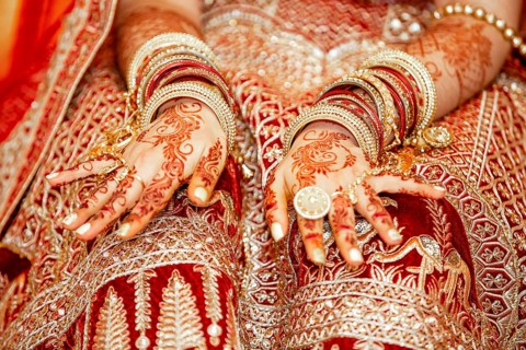 Traditional bridal jewelry and henna decoration on the hands of Hindu bride on her wedding day