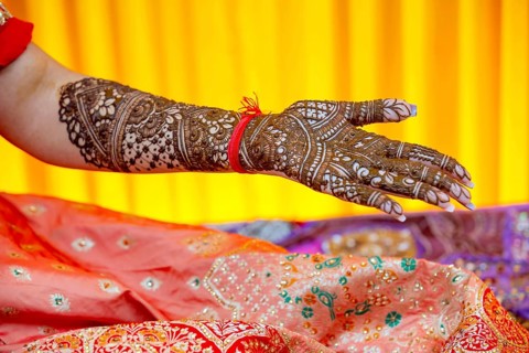 Beautiful henna design on the hand of a Hindu bride on her wedding eve