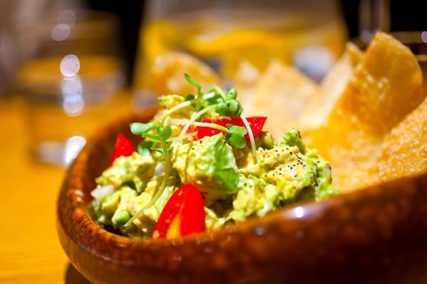 Fresh avocado and shrimps salad with nachos on side