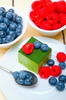 Green tea matcha mousse cake with raspberries and blueberries on top