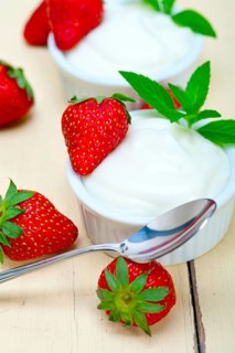 Organic Greek yogurt and strawberry over white rustic wood table