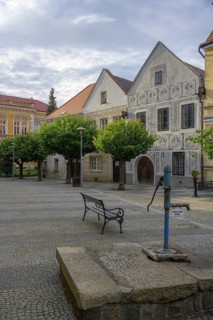 Historical old town with sgraffito house and old fountain