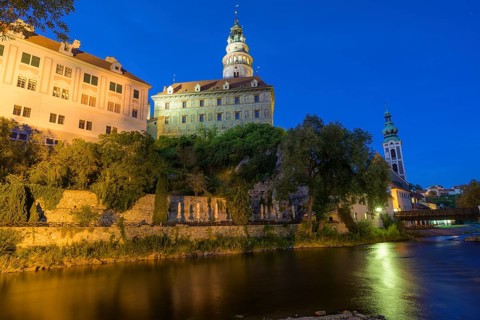 Vltava river and castle with Zamecka vez tower in the evening