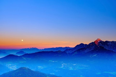 The peaks of Hoher Dachstein and hoher Goell in the last evening light and moonrise