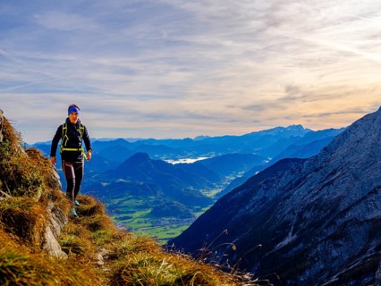 Mountaineer walking on a narrow path above the Salzach valley