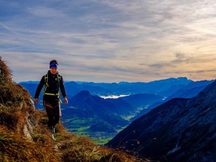 Mountaineer walking on a narrow path above the Salzach valley