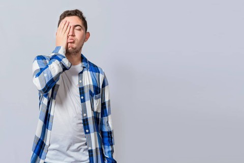 Exhausted person putting the palm of his hand on his face. Tired and exhausted man covering his face with the palm of his hand isolated