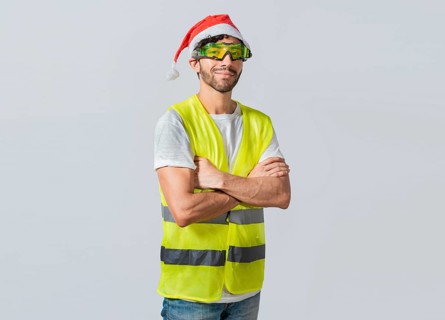 Portrait of a smiling engineer in a christmas hat