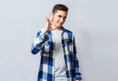 Handsome guy gesturing everything is ok
