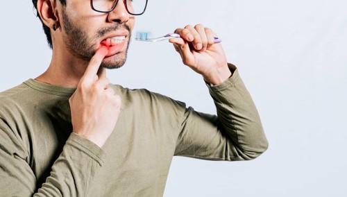 People holding toothbrush with gum pain. Man holding toothbrush with gum pain