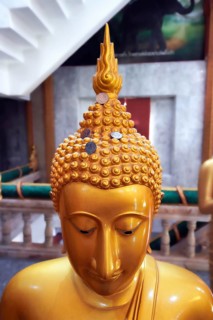 Buddha statue with coins as donation