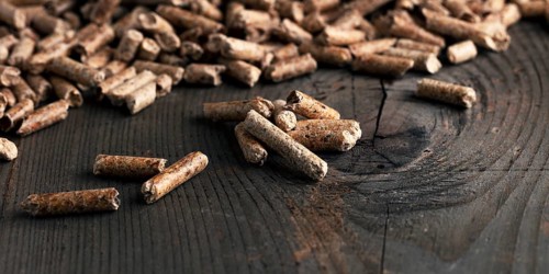 Wood pellets on wooden background