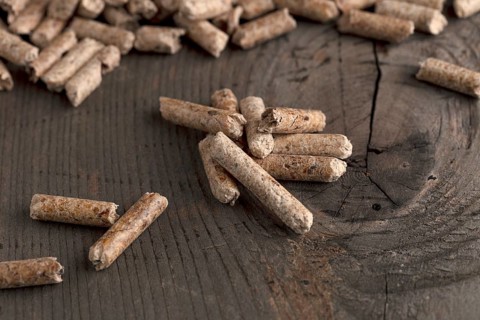 Wood pellets on wooden background