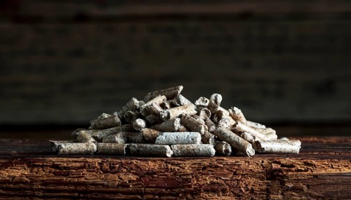 Wood pellets on wooden background