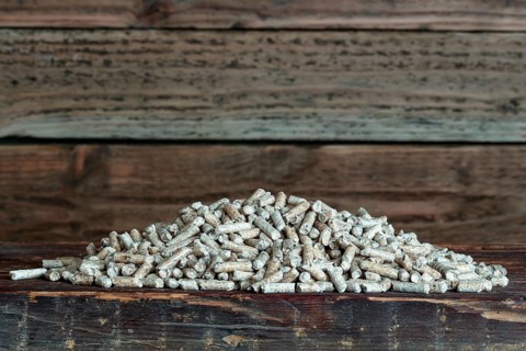 Wood pellets on wooden background
