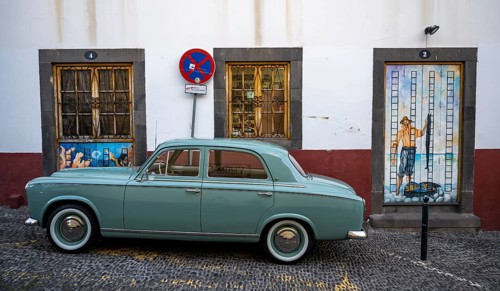Vintage car in front of a house facade