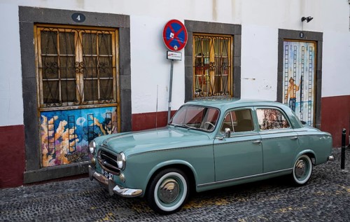 Vintage car in front of a house facade