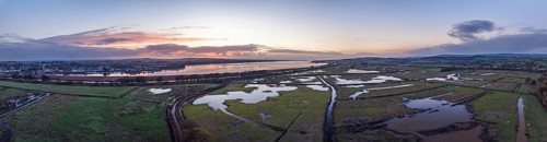Sunrise over Wetlands and meadows in RSPB Exminster and Powderham Marshe from a drone