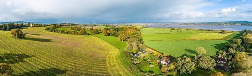The Belvedere Tower over Powderham Park from a drone in Autumn Colors