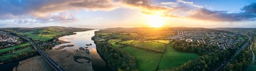 Panorama of Sunrise over Newton Abbot Bridge and River Teign from a drone