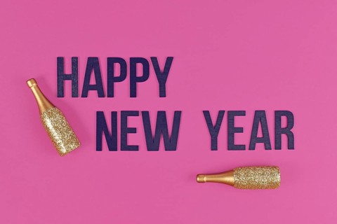 Happy New Year text with golden champagne bottles