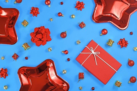 Christmas flat lay wit red star shaped paper party plates