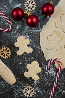 Overhead flat lay concept for baking Christmas cookies with rolled out cookie dough