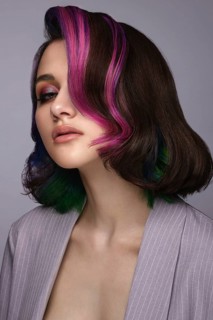 Portrait of beautiful woman with multi-colored hair and classic make up and hairstyle