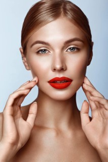 Beautiful girl with red lips and classic makeup. Beauty face. Photo taken in the studio