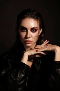 Portrait of a beautiful woman in a rock style image with creative makeup and hairstyle