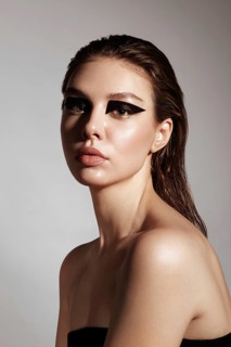 Portrait of a beautiful woman in a rock style image with creative makeup and hairstyle