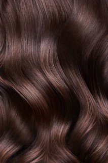 A closeup view of a bunch of shiny curls brown hair